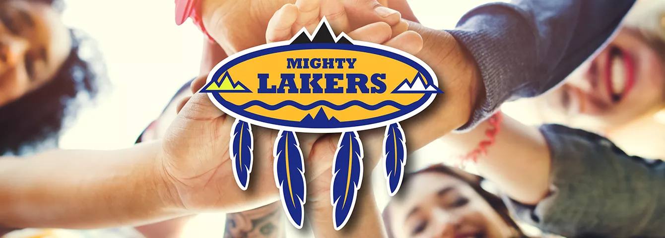 Student's hands over Lake Valley Navajo School logo.
